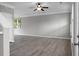 Open-concept living room with new floors, ceiling fan, and plenty of natural light at 209 Killarney Trl, Moncks Corner, SC 29461