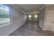Bright living room with gray vinyl flooring, neutral walls, and multiple windows at 209 Killarney Trl, Moncks Corner, SC 29461
