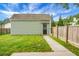 Green outbuilding includes a black door with decorative panes and is surrounded by a wooden fence at 209 Killarney Trl, Moncks Corner, SC 29461