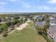 Aerial view of a golf course community with ponds, trees, and beautiful homes at 21 Morgan Place Dr, Isle of Palms, SC 29451