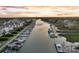 Aerial view of a waterway with houses, docks, and boats at sunset, showcasing waterfront living at 21 Morgan Place Dr, Isle of Palms, SC 29451