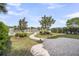 Serene backyard featuring a winding brick path, manicured lawn, and lush greenery near the waterway at 21 Morgan Place Dr, Isle of Palms, SC 29451