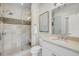 Beautifully appointed bathroom featuring neutral tile, glass shower, modern vanity, and ample natural light at 21 Morgan Place Dr, Isle of Palms, SC 29451