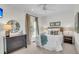Comfortable bedroom with neutral tones, a woven headboard, and a decorative sunburst mirror at 21 Morgan Place Dr, Isle of Palms, SC 29451