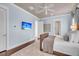 A contemporary style bedroom featuring a ceiling fan, a TV, and an ensuite bath with a glass-enclosed shower at 21 Morgan Place Dr, Isle of Palms, SC 29451