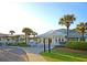The Harbor Golf Apartments clubhouse featuring inviting architecture, landscaping, and palm trees at 21 Morgan Place Dr, Isle of Palms, SC 29451