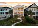 Beautiful two-story home with double porches, landscaped yard, and charming brick pathway at 21 Morgan Place Dr, Isle of Palms, SC 29451