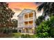 Elegant two-story home featuring double porches and well-manicured landscaping at 21 Morgan Place Dr, Isle of Palms, SC 29451