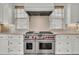 This kitchen has a large stainless steel stove with a modern range hood and warm lighting at 21 Morgan Place Dr, Isle of Palms, SC 29451