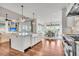 Bright open-concept living space featuring a kitchen island, stainless appliances, and hardwood floors at 21 Morgan Place Dr, Isle of Palms, SC 29451