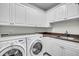Well-organized laundry room equipped with modern appliances, plenty of storage cabinets, and countertop space at 21 Morgan Place Dr, Isle of Palms, SC 29451