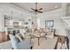 Spacious living room with a kitchen in the background, with hardwood floors and neutral tones at 21 Morgan Place Dr, Isle of Palms, SC 29451