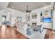 Open-concept living room with a fireplace, built-in shelving, and hardwood floors offers an inviting space at 21 Morgan Place Dr, Isle of Palms, SC 29451