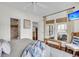 Bright main bedroom featuring hardwood floors, ensuite bath, ceiling fan, and direct access to the outdoor deck at 21 Morgan Place Dr, Isle of Palms, SC 29451
