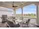 Covered patio with outdoor seating, stainless steel grill, and scenic waterfront views with bright blue sky at 21 Morgan Place Dr, Isle of Palms, SC 29451