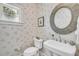 Charming powder room featuring a pedestal sink, seashell wallpaper, and natural light at 21 Morgan Place Dr, Isle of Palms, SC 29451