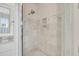 A tile shower area with decoratively patterned tile flooring and a shower niche for storage and personal items at 21 Morgan Place Dr, Isle of Palms, SC 29451