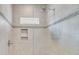 Tiled shower stall with a glass partition, a rainfall shower head, and built-in shelving at 21 Morgan Place Dr, Isle of Palms, SC 29451