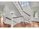 Elegant staircase with white railings, wooden steps, and plenty of natural light at 21 Morgan Place Dr, Isle of Palms, SC 29451