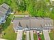 Aerial view of townhomes with fenced in yards, driveways, parked cars, and lush green lawns at 210 Grand Palm Ln, Summerville, SC 29485