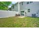 Private back yard area featuring white fence, grassy area, and patio with seating at 210 Grand Palm Ln, Summerville, SC 29485