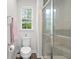 Bathroom features tiled shower, toilet and window at 210 Grand Palm Ln, Summerville, SC 29485