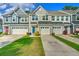 Charming townhome featuring modern architecture, a driveway, and well-maintained landscaping at 210 Grand Palm Ln, Summerville, SC 29485