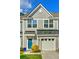 Charming townhome with a bright blue front door, well-manicured lawn and a one car garage at 210 Grand Palm Ln, Summerville, SC 29485