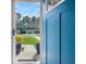 View through the open front door to the townhomes across the street and the manicured lawn at 210 Grand Palm Ln, Summerville, SC 29485