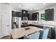 Modern kitchen features stainless steel appliances, dark cabinets, and granite countertops at 210 Grand Palm Ln, Summerville, SC 29485