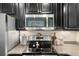 Stainless steel microwave and oven appliances with granite countertops at 210 Grand Palm Ln, Summerville, SC 29485
