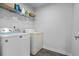 Efficient laundry room area with washer, dryer, and shelving for storage at 210 Grand Palm Ln, Summerville, SC 29485