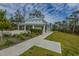 Community clubhouse surrounded by manicured green spaces and a sidewalk at 2282 Braided Ln, Mount Pleasant, SC 29466