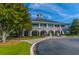 Elegant clubhouse with an arched entrance, balcony, and lush landscaping, perfect for community gatherings at 2282 Braided Ln, Mount Pleasant, SC 29466