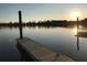 A wooden dock extends into the tranquil water, perfect for enjoying sunsets and waterfront activities at 2282 Braided Ln, Mount Pleasant, SC 29466