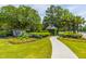 The 'Dunes West' entrance is marked by manicured landscaping and elegant signage, showcasing the community's upscale appeal at 2282 Braided Ln, Mount Pleasant, SC 29466