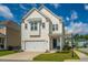 Charming two-story home featuring a two-car garage, landscaped yard, and a welcoming blue front door at 2282 Braided Ln, Mount Pleasant, SC 29466