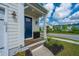 Charming front door with blue door, black planter, and manicured landscaping at 2282 Braided Ln, Mount Pleasant, SC 29466