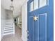 Inviting foyer with a blue front door, hardwood floors, and stairs leading to the upper level at 2282 Braided Ln, Mount Pleasant, SC 29466