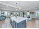 Open-concept kitchen flowing into the living and dining areas, featuring an island with seating at 2282 Braided Ln, Mount Pleasant, SC 29466