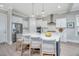 Modern kitchen with white cabinetry, stainless steel appliances, an island with seating, and stylish pendant lighting at 2282 Braided Ln, Mount Pleasant, SC 29466