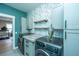 Laundry room with custom wallpaper and cabinets and gray front load washer and dryer at 2282 Braided Ln, Mount Pleasant, SC 29466