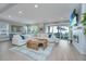 Bright living room with a cozy fireplace, large sectional sofa, and access to the outdoor patio at 2282 Braided Ln, Mount Pleasant, SC 29466