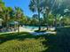 A refreshing pool area surrounded by palm trees and lounge chairs offers a serene escape for residents at 2282 Braided Ln, Mount Pleasant, SC 29466