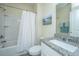 Bright bathroom featuring a shower-tub combo with a curtain, granite countertop, and modern fixtures at 2302 Hamlin Sound Cir, Mount Pleasant, SC 29466