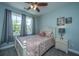 Cozy bedroom with a large window, ceiling fan, and soft blue walls at 2302 Hamlin Sound Cir, Mount Pleasant, SC 29466