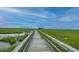 Long wooden boardwalk stretches across the marsh, offering serene views and a tranquil path to explore nature at 2302 Hamlin Sound Cir, Mount Pleasant, SC 29466
