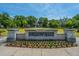 Exterior view of Brigade Hall at a community center, with a manicured lawn, trees, and a flower bed at 2302 Hamlin Sound Cir, Mount Pleasant, SC 29466