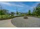 Community fire pit with stone seating area, perfect for gatherings with views of the lake and surrounding homes at 2302 Hamlin Sound Cir, Mount Pleasant, SC 29466