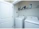 Well-lit laundry room with white appliances, shelving, and ample space for efficient chores at 2302 Hamlin Sound Cir, Mount Pleasant, SC 29466